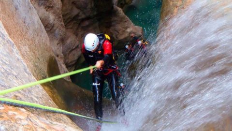 person abseiling into water
