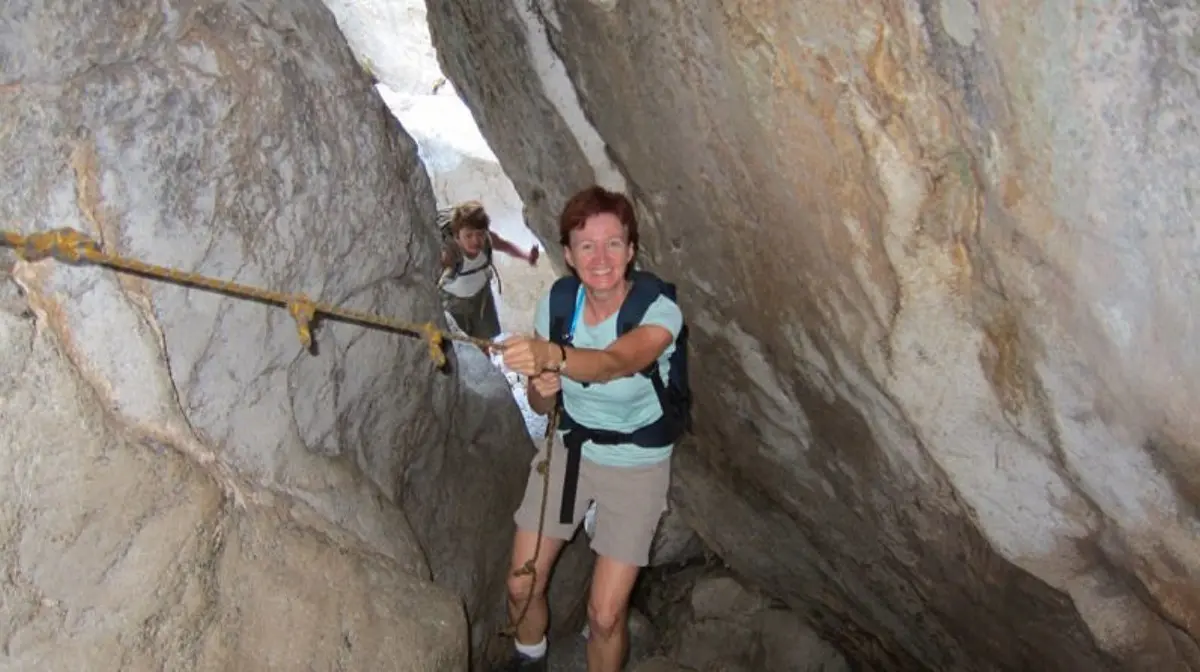 A person smiling and holding a rope while on his outdoor activity in Mallorca