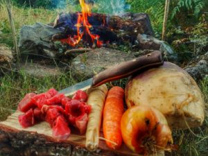 Cooking vegetables on a camp fire.