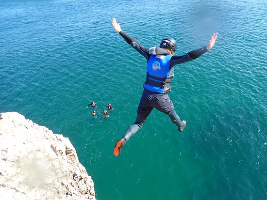 person cliff jumping in the sea