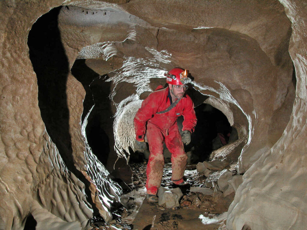 A man in the midst of an exciting adventure caving in Wales