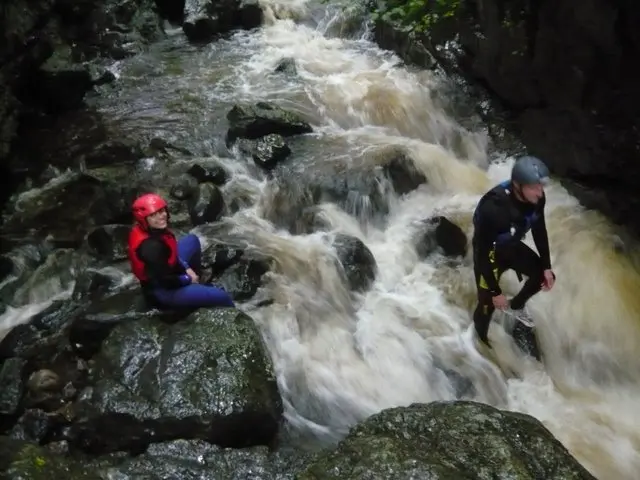Two individuals on a waterfall in Cardiff, Wales