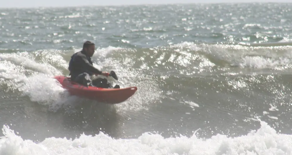 A person kayaking in the ocean