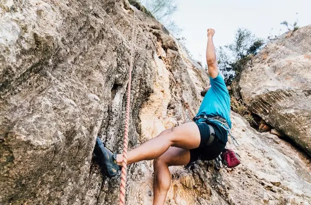 person outdoor rock climbing