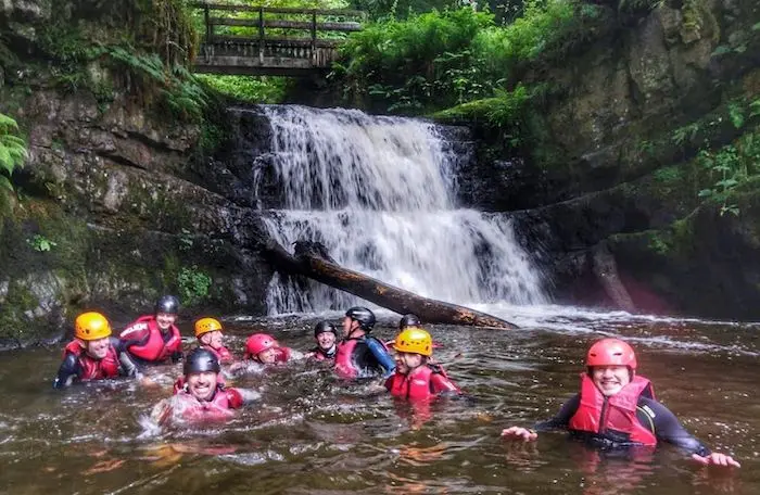 men swimming in a lake