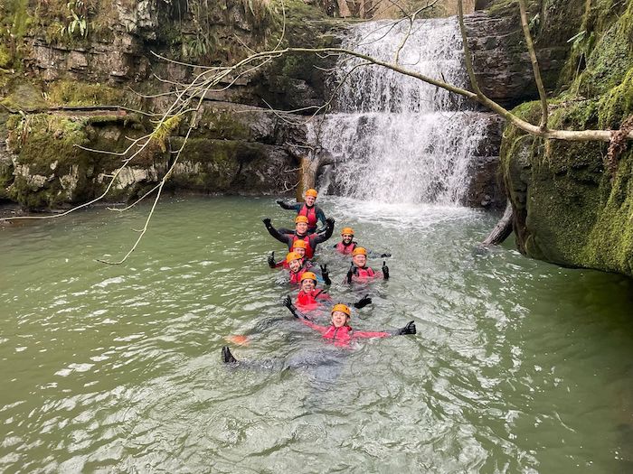 group of people swimming in a lake