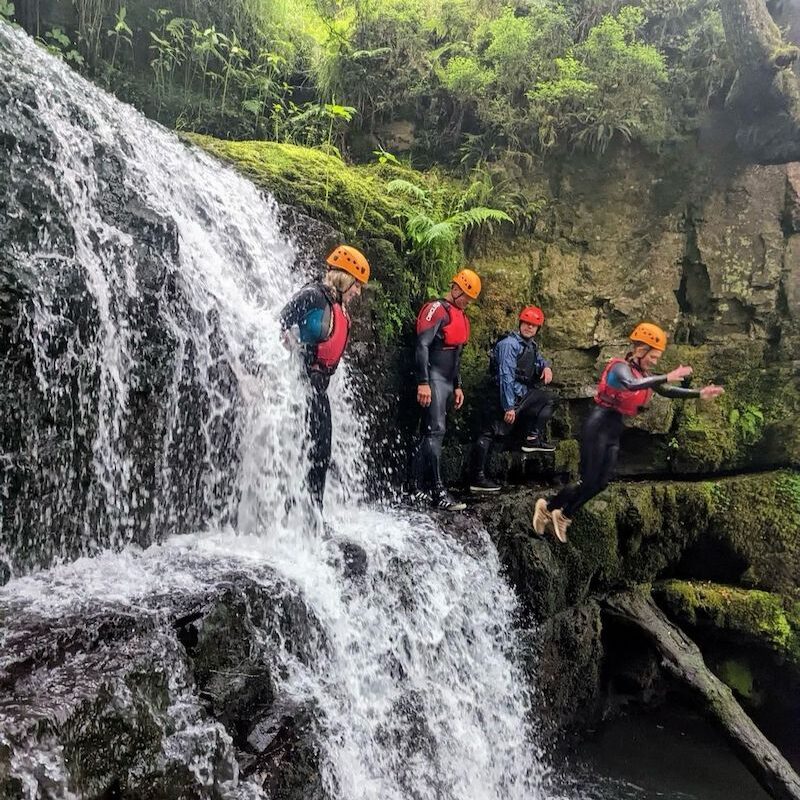 people jumping during gorge walking