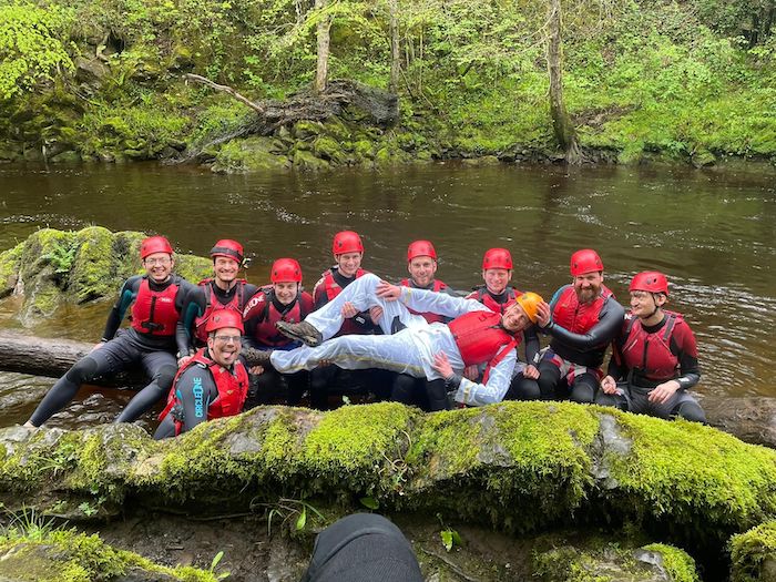 men at stag do gorge walking posing in a line