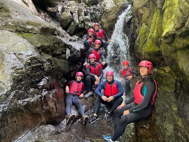 group of people gorge walking in wales