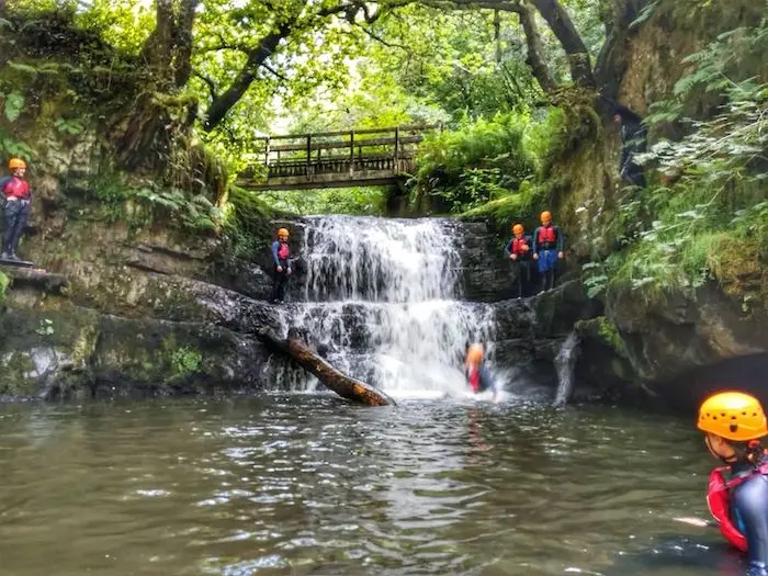 Group of people on a gorge walking adventure in Wales.