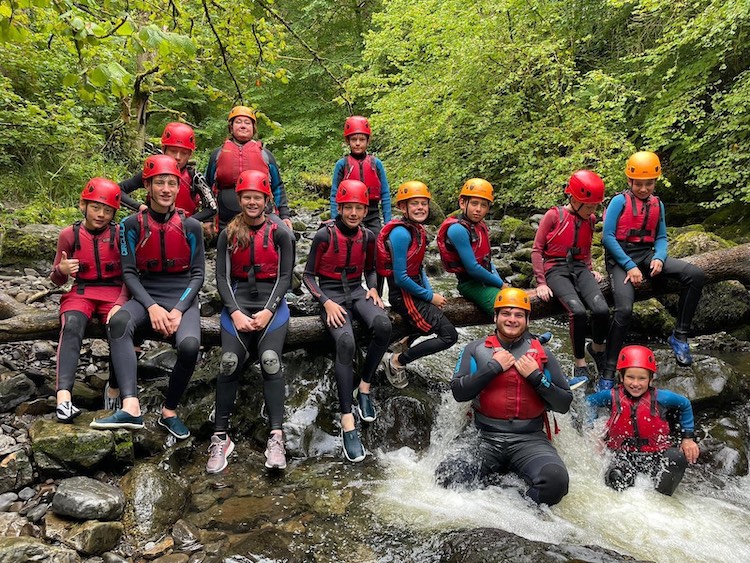 photo of children and teenagers gorge walking during a school trip