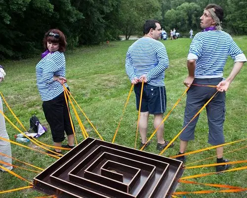 Two men and a woman playing enigma game for their team building.