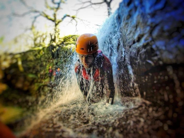 A person canyoning in Wales captured mid-action as he traverses a waterfall.