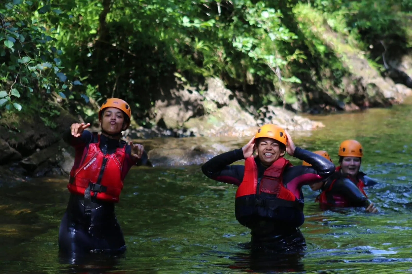 3 young people enjoying gorge walking in Wales