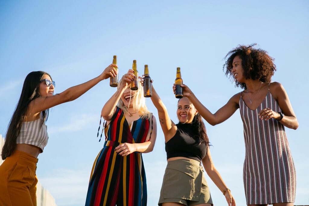 Four ladies raise their bottles in a joyful toast as they celebrate the bride-to-be on her hen-do in Cardiff