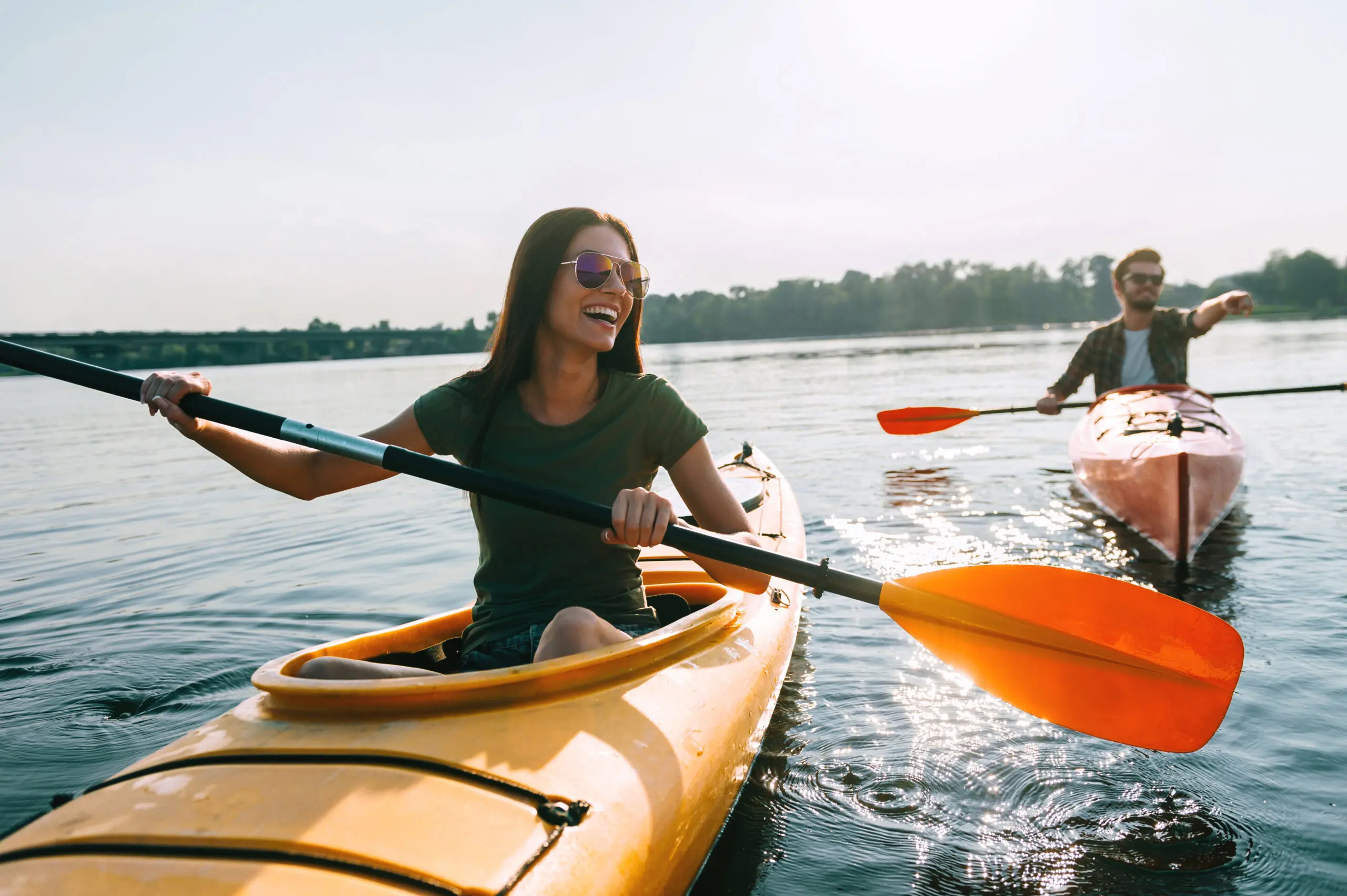 A man and woman kayaking enjoy kayaking adventure