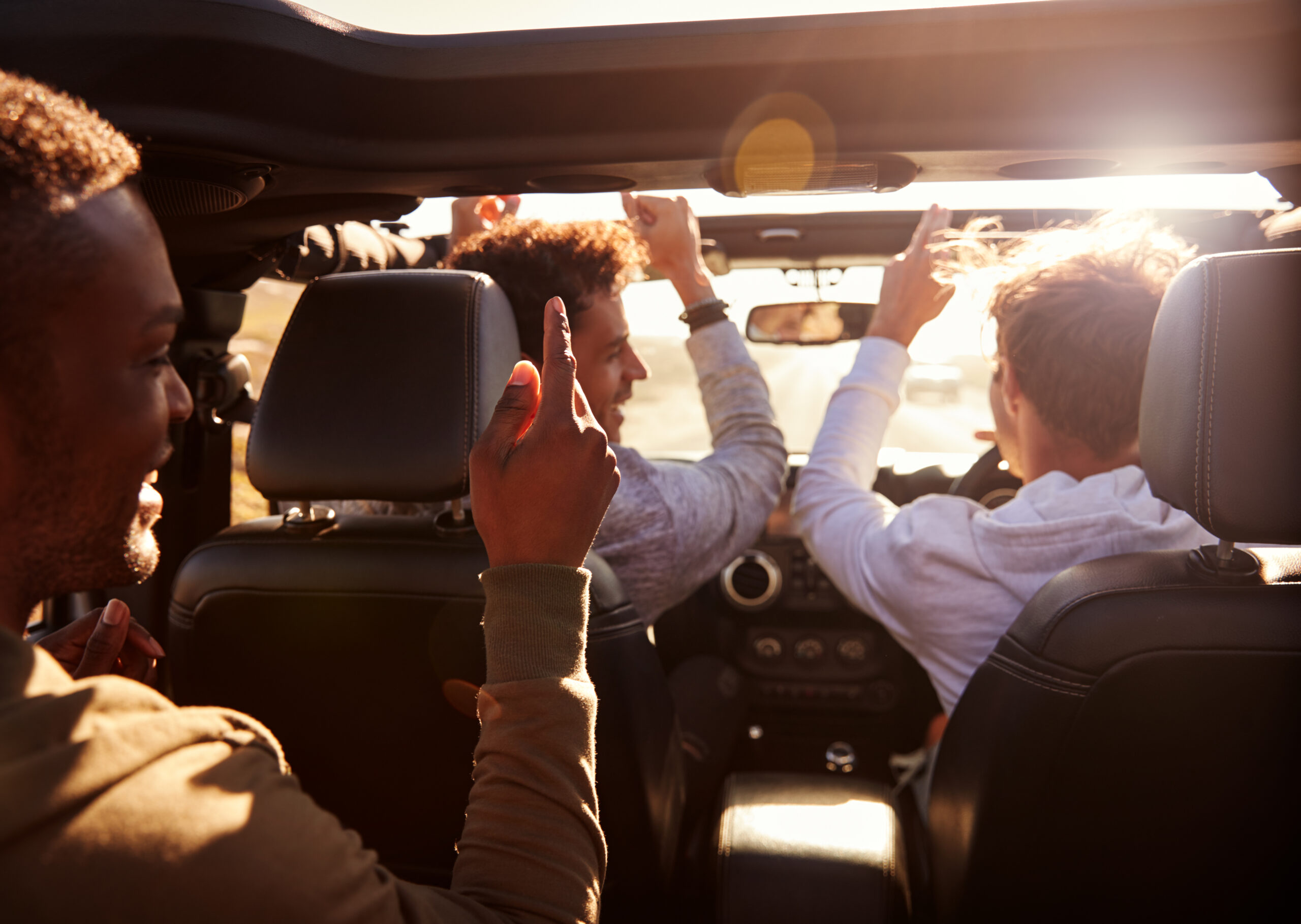 Group of men looking excited inside a vehicle as they head to an adventure-packed stag-do in Cardiff