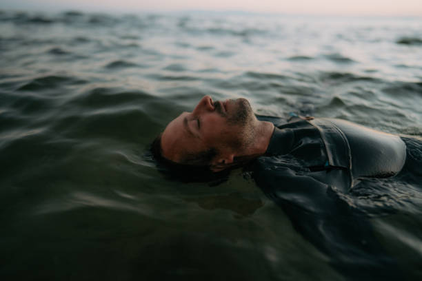 a man floating in the sea, enjoying a relaxing day