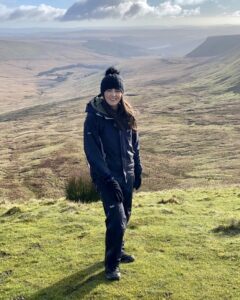 Danielle McMullen, co-owner of Blue Ocean Activities standing in the middle of a scenic land