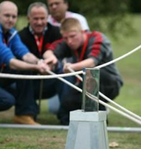 Four men doing the enigma team building activity