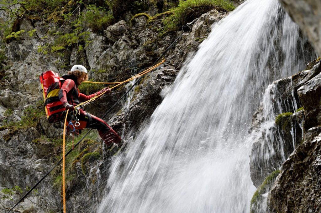 A person abseiling in a waterfall