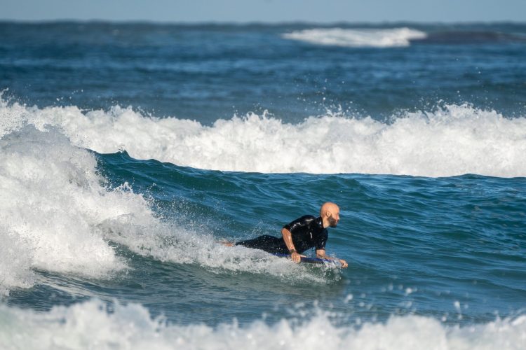 A man bodyboarding in the sea