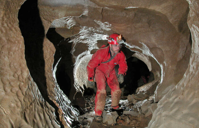 A man in the midst of an exciting adventure caving in Wales
