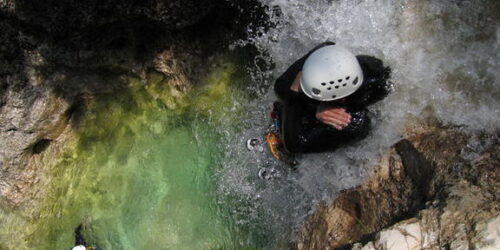 A person on a waterfall during their adventure holidays in France