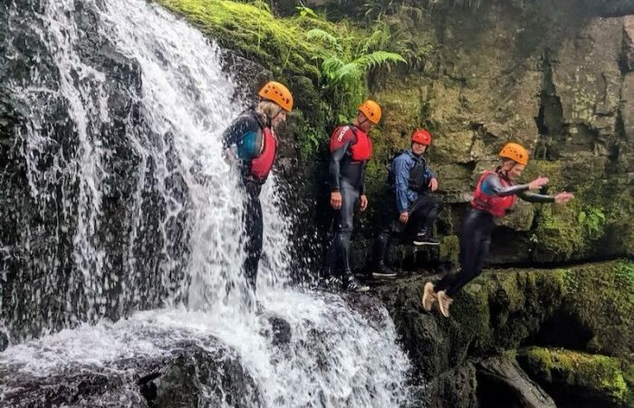 people jumping during gorge walking