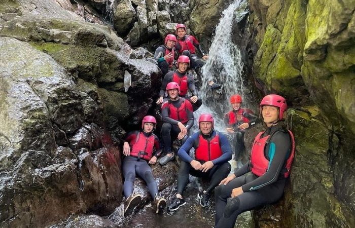 group of people gorge walking in wales